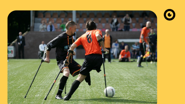 A person with crutches playing soccer.